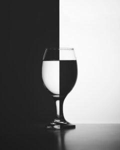 a black and white photo of a wine glass