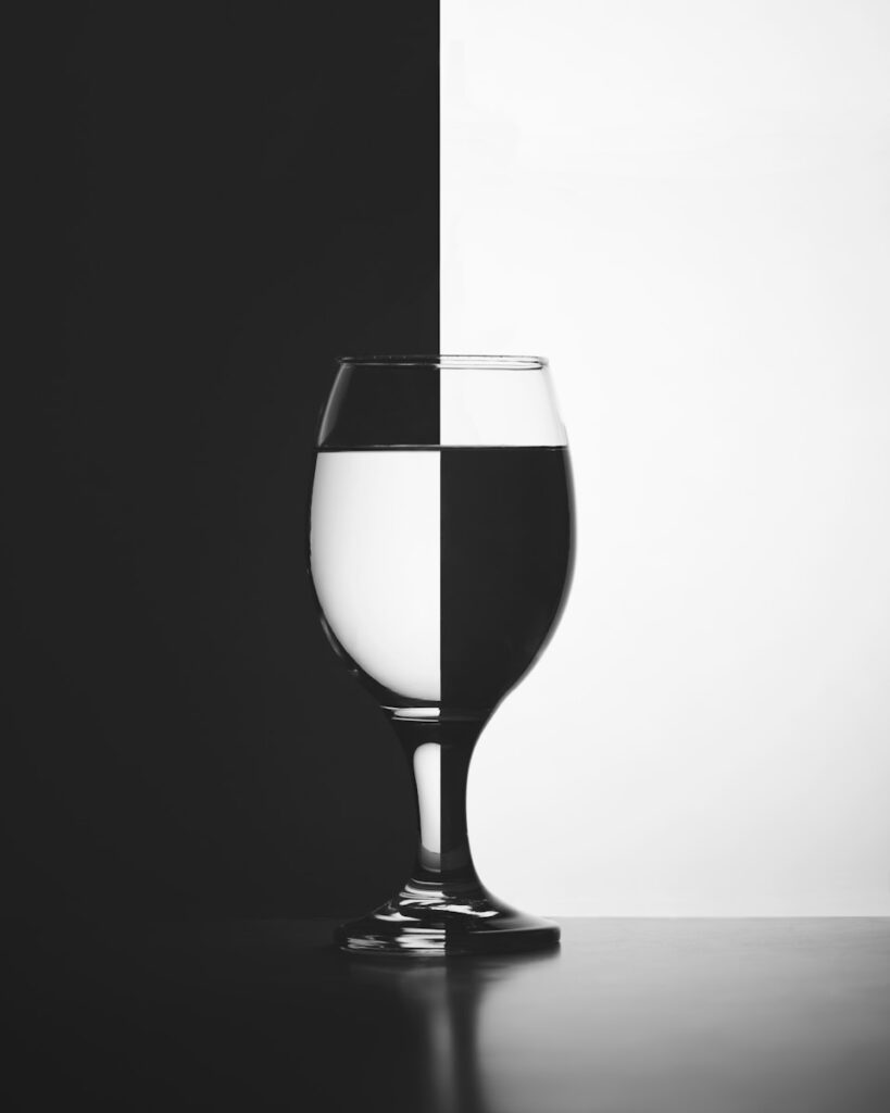 a black and white photo of a wine glass
